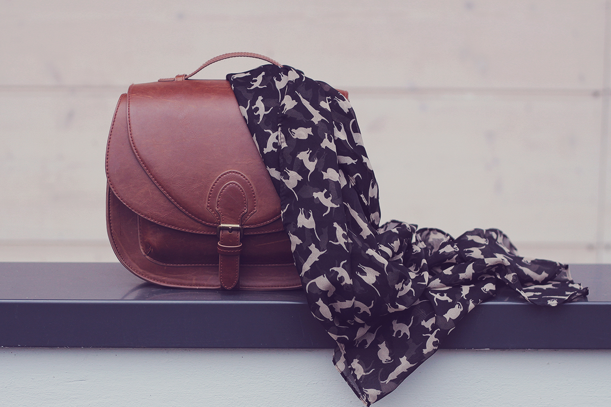 cat pattern scarf and brown handbag