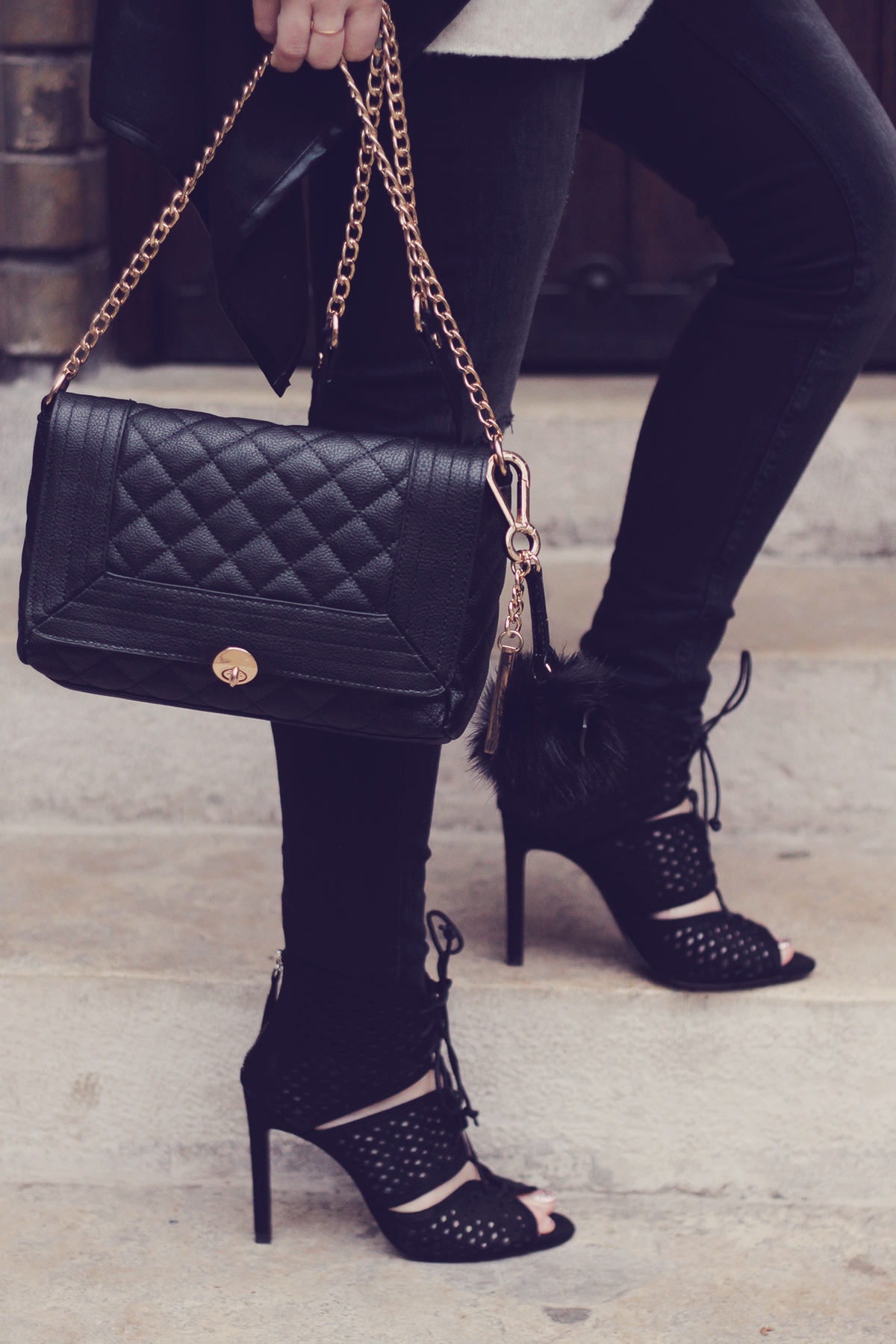 black cut high-heeled sandals and chain purse