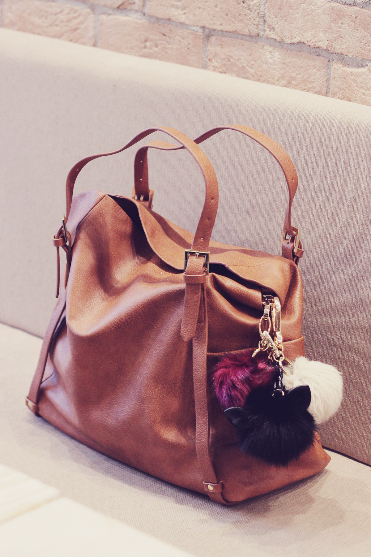 large brown tote bag with pom-poms