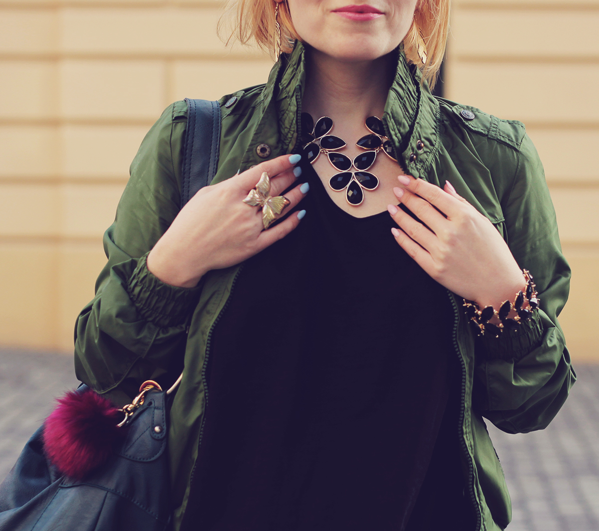black flower necklace and green bomber jacket