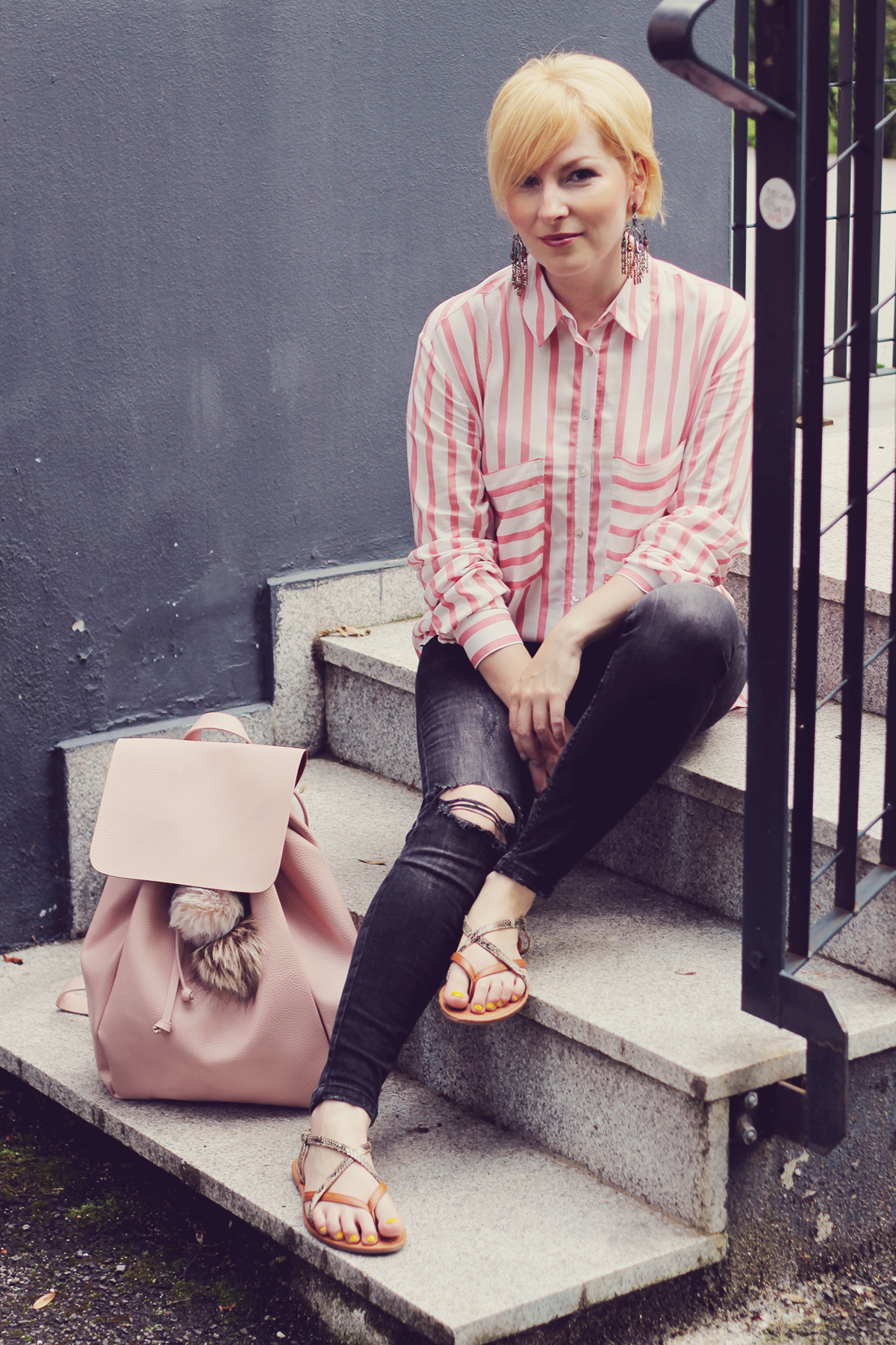 pink backpack with sandals and jeans