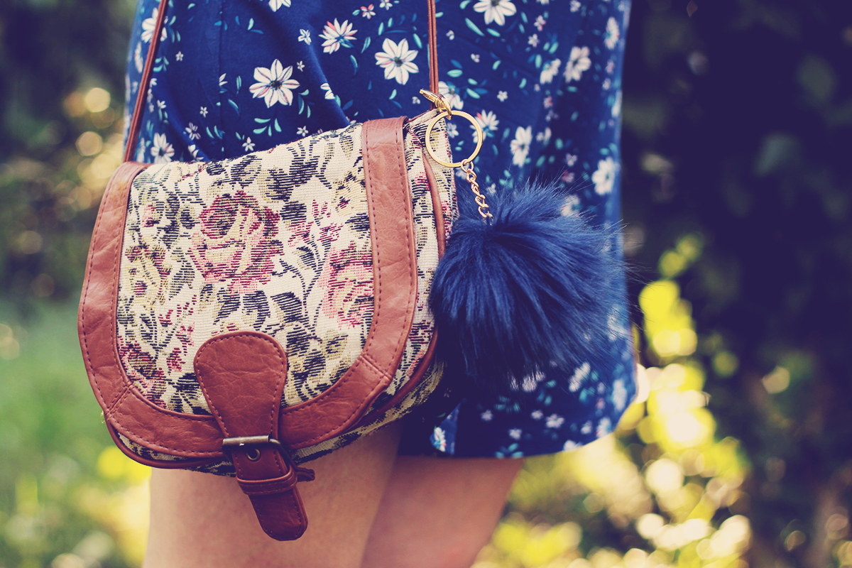 blue pom-pom and floral purse