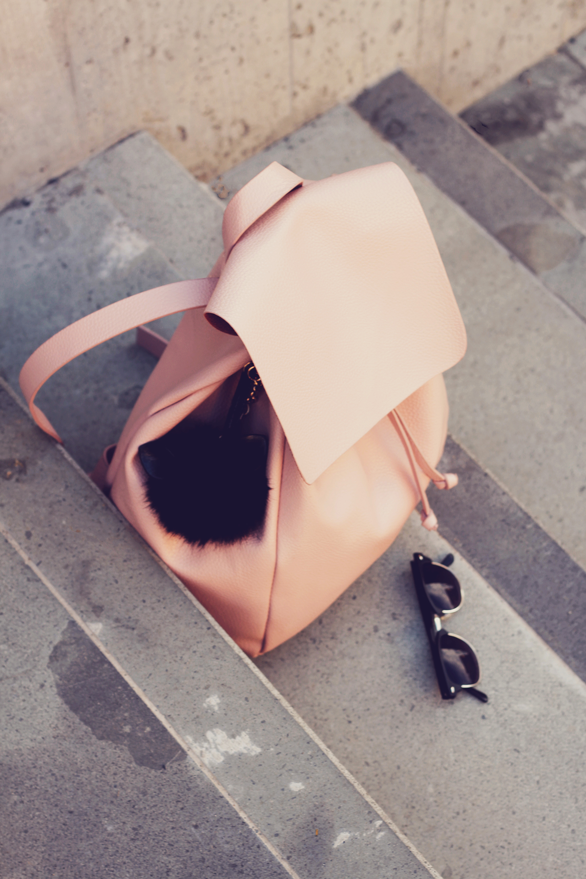 pink backpack and pom-pom