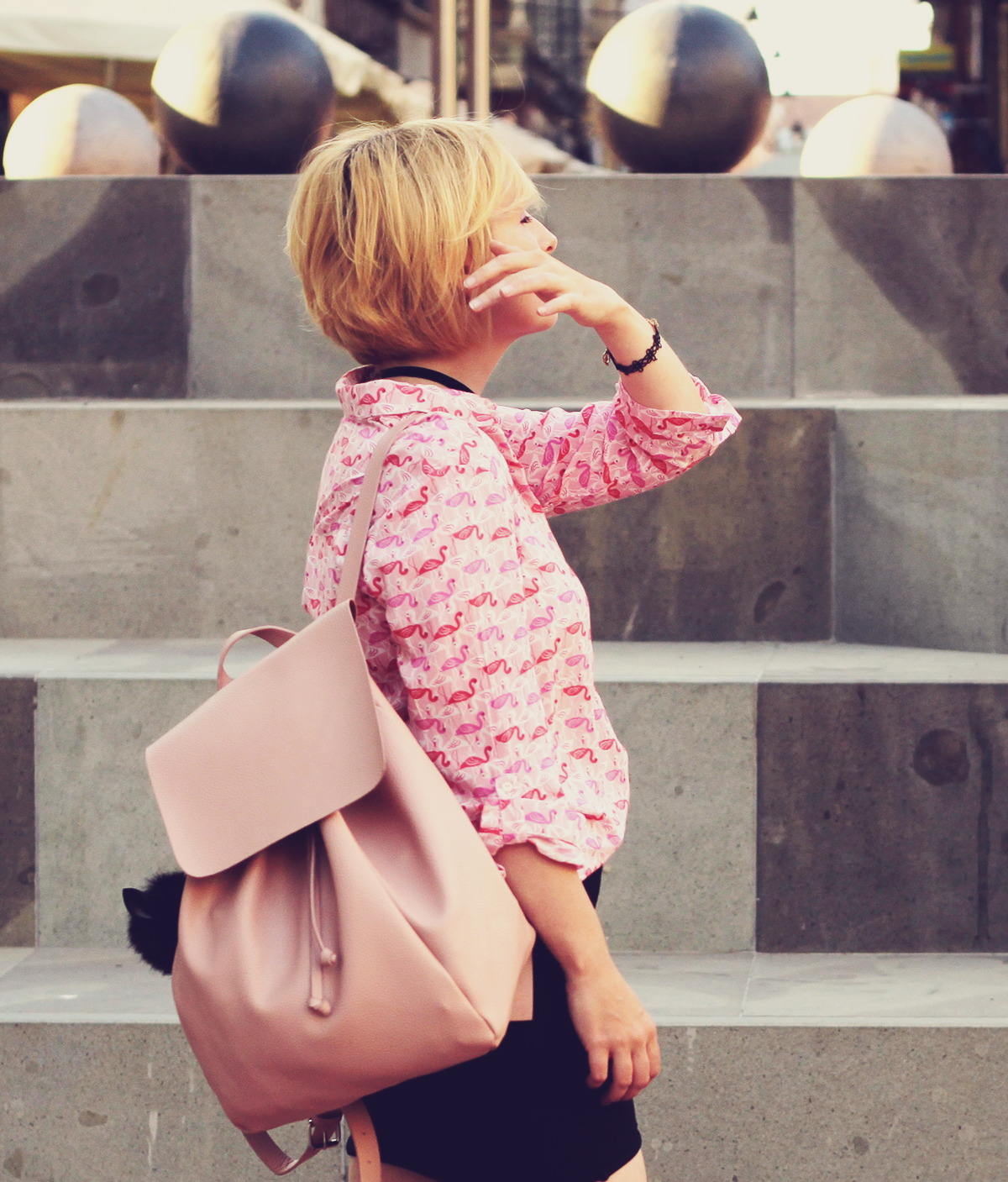 pink flamingo shirt and pink backpack with pom-pom