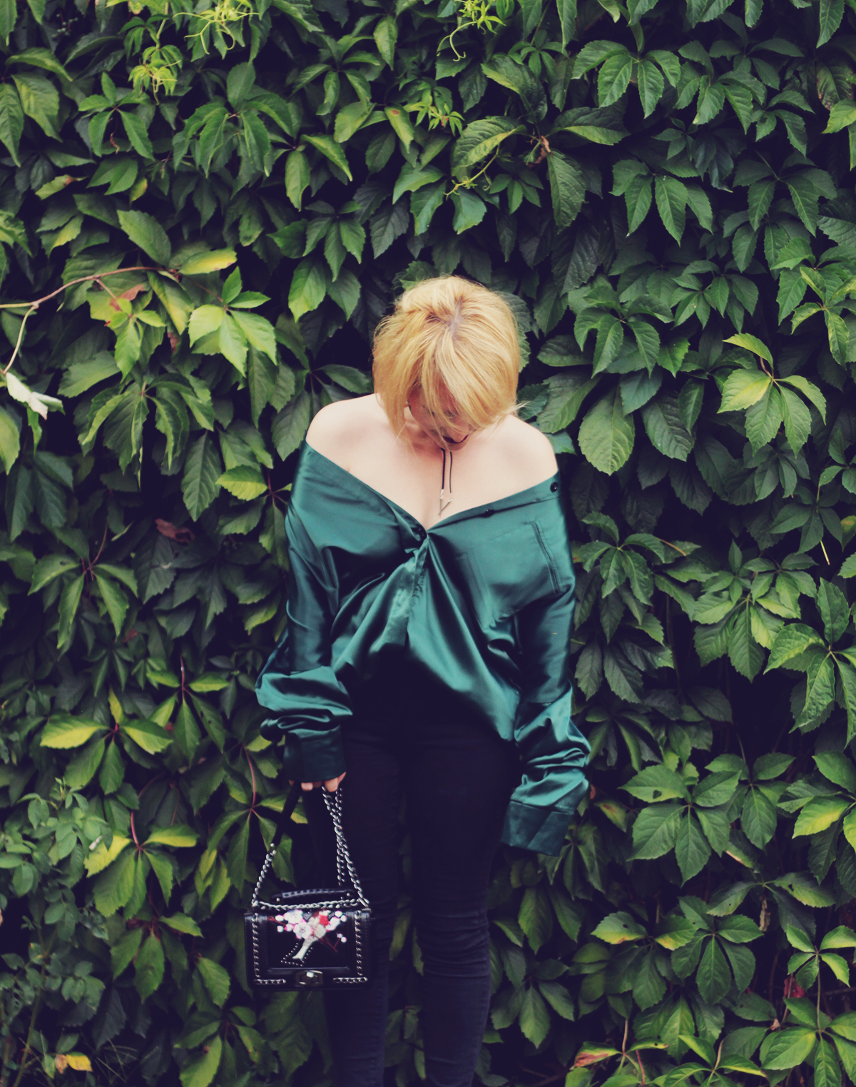 green satin oversized shirt and embroidered shoulder bag