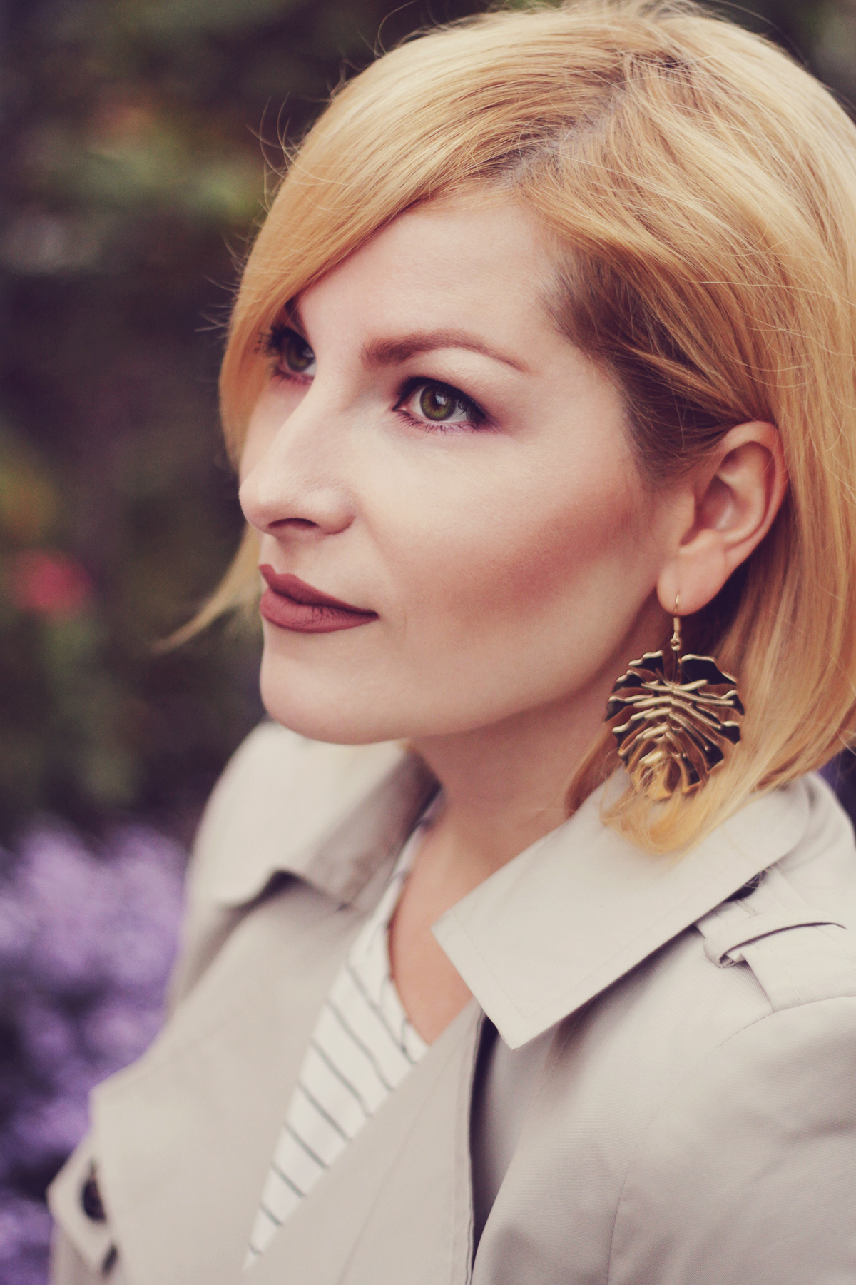 matte lips, tropical leaf earrings, short trench, classic burgundy make-up