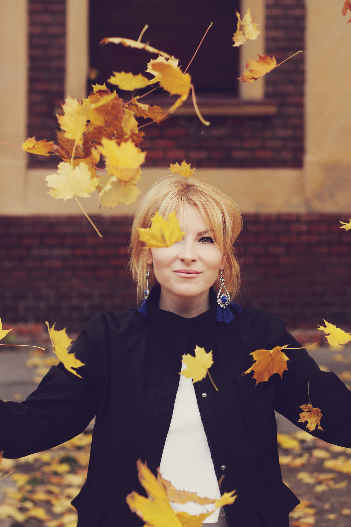 autumn, autumn leafs in the air, girl, portrait, tassel earrings, navy jacket, white top