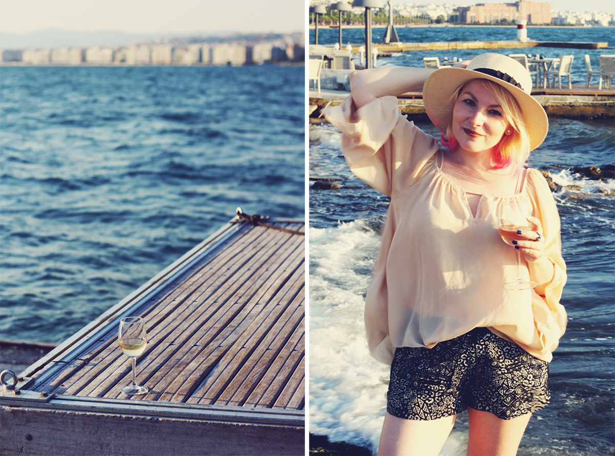 Thessaloniki, travel fashion, travel wear, Summer style, loose nude top, straw hat, living my best life, glass of wine, tribal shorts, travel post, blonde hair with pink highlights