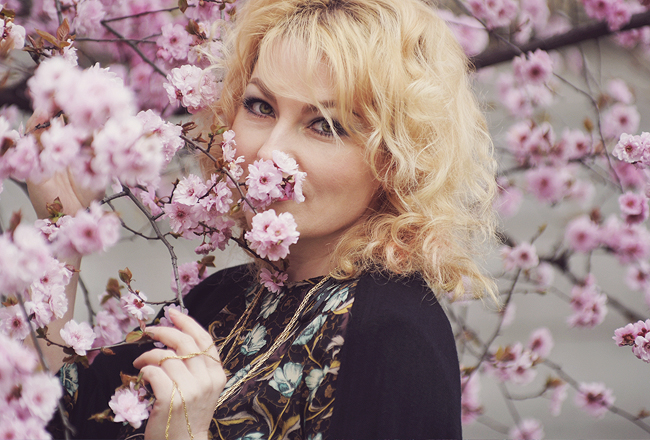 spring look, pink cherry blossoms, spring, black scarf, curly blonde hair, floral top, Christian Dior necklace